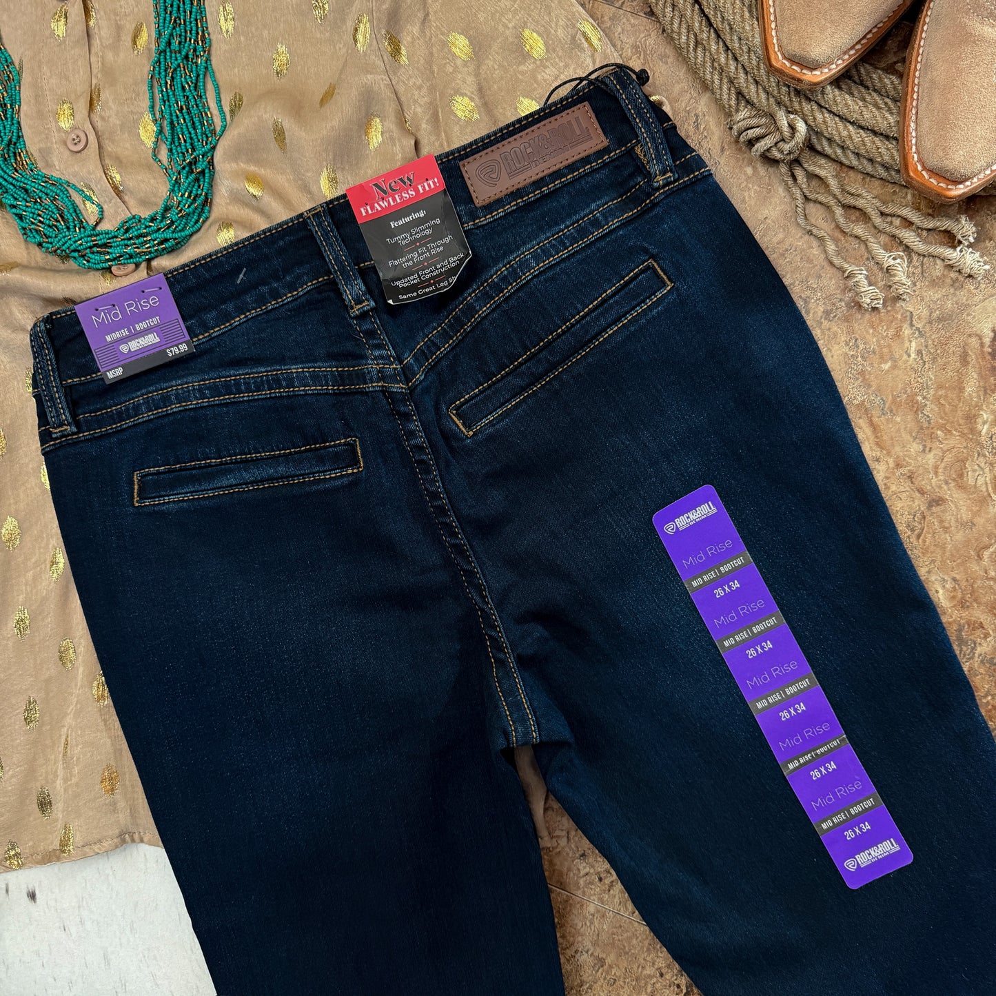 Close-up of welt back pocket detail on dark wash denim