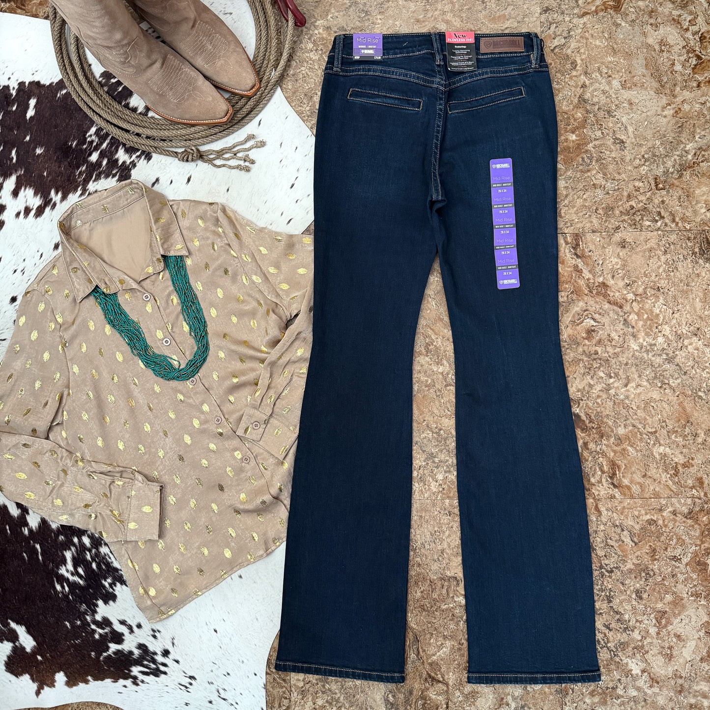 Back full view showing bootcut leg and clean welt back pocket design on dark wash denim